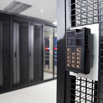 Keypad access control system mounted on a rack in a server room.